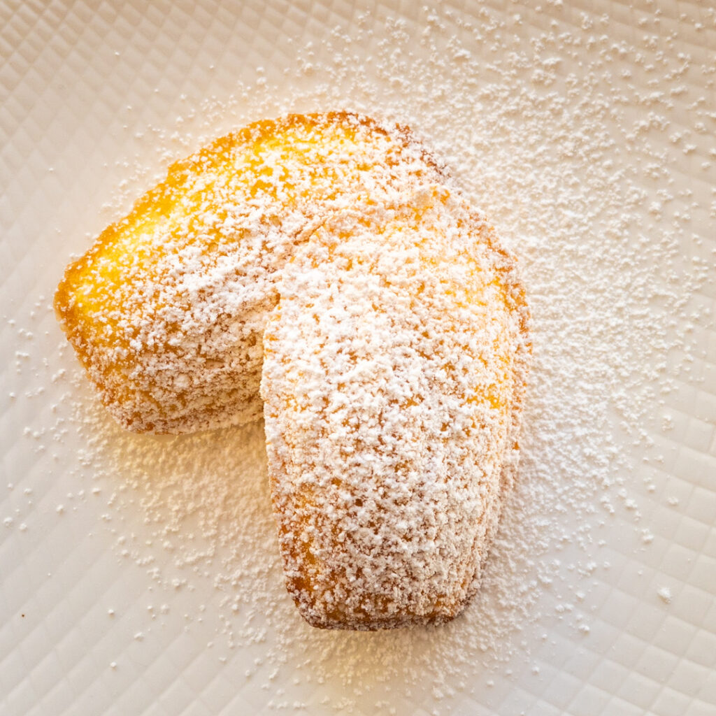 Close up of Orange Madeleines with powdered sugar