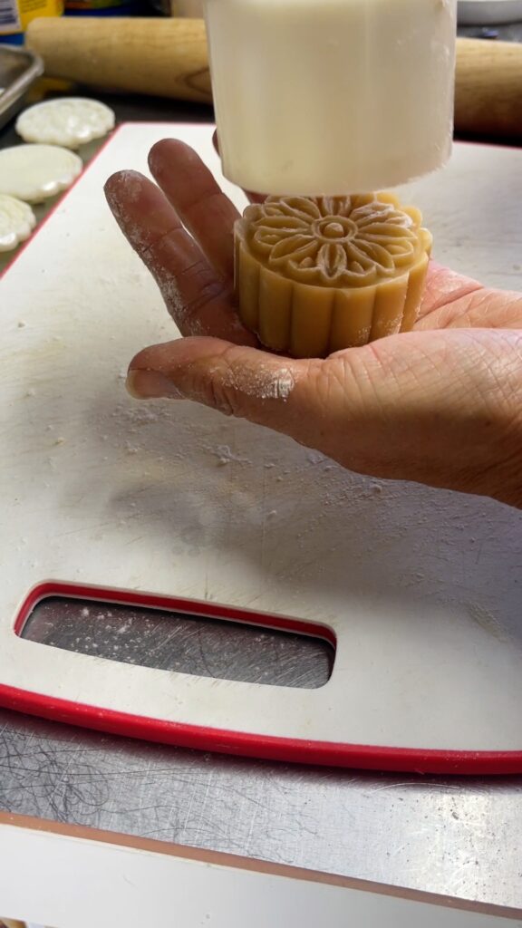 a mooncake coming out of the mold