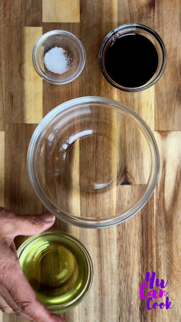 Glass Bowls containing balsamic dressing, salt, and extra virgin olive oil, with an empty bowl to be used to whisk together ingredients to make a dressing for the insalata caprese salad.