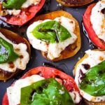 Insalata Caprese with a vibrant photo that captures the lush red of organic heirloom tomatoes, the pristine white of buffalo mozzarella, and the fresh green of basil leaves, all artfully drizzled with golden olive oil and rich balsamic vinegar dressing.